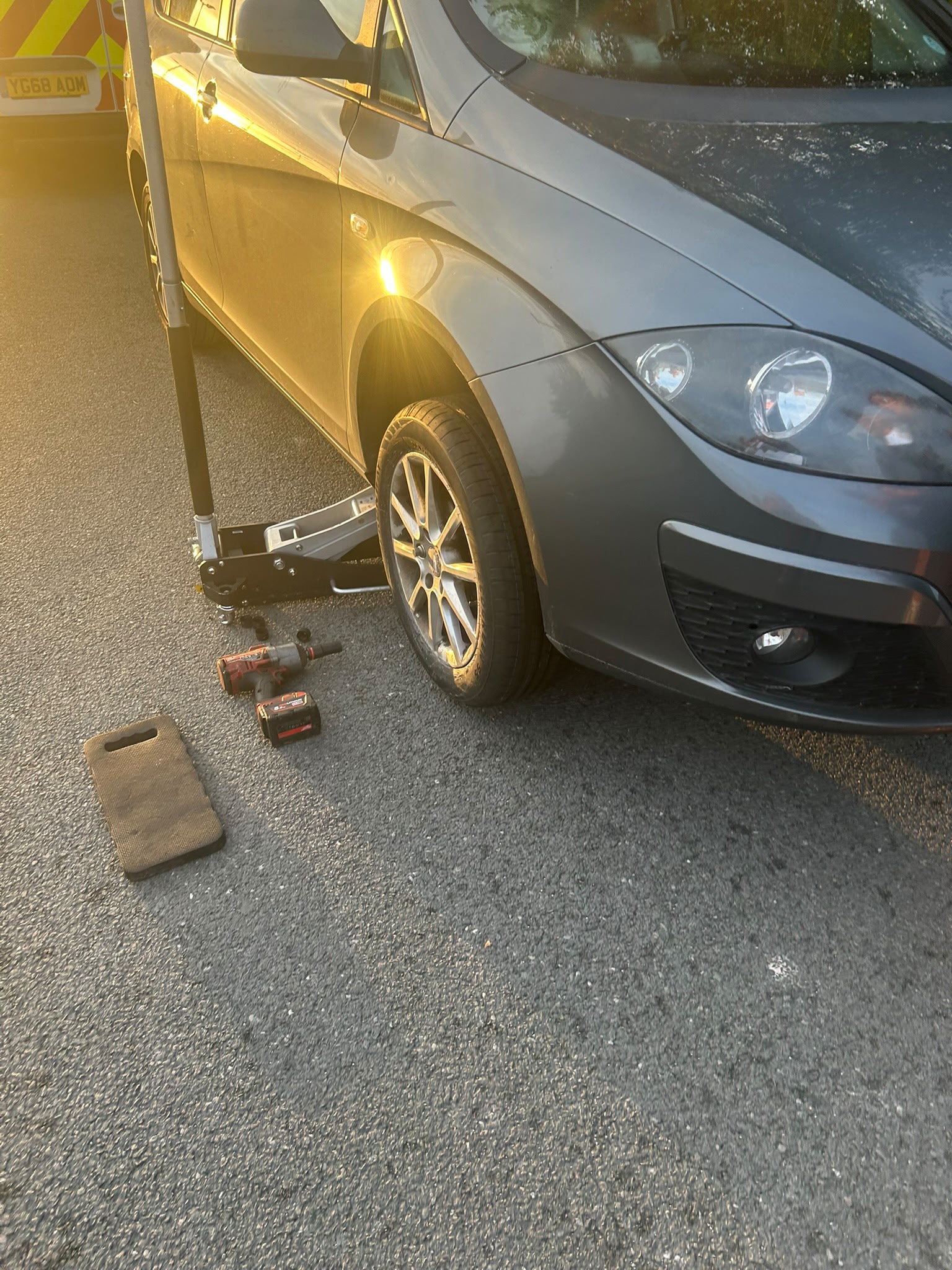Car beside a service van during a mobile wheel appointment