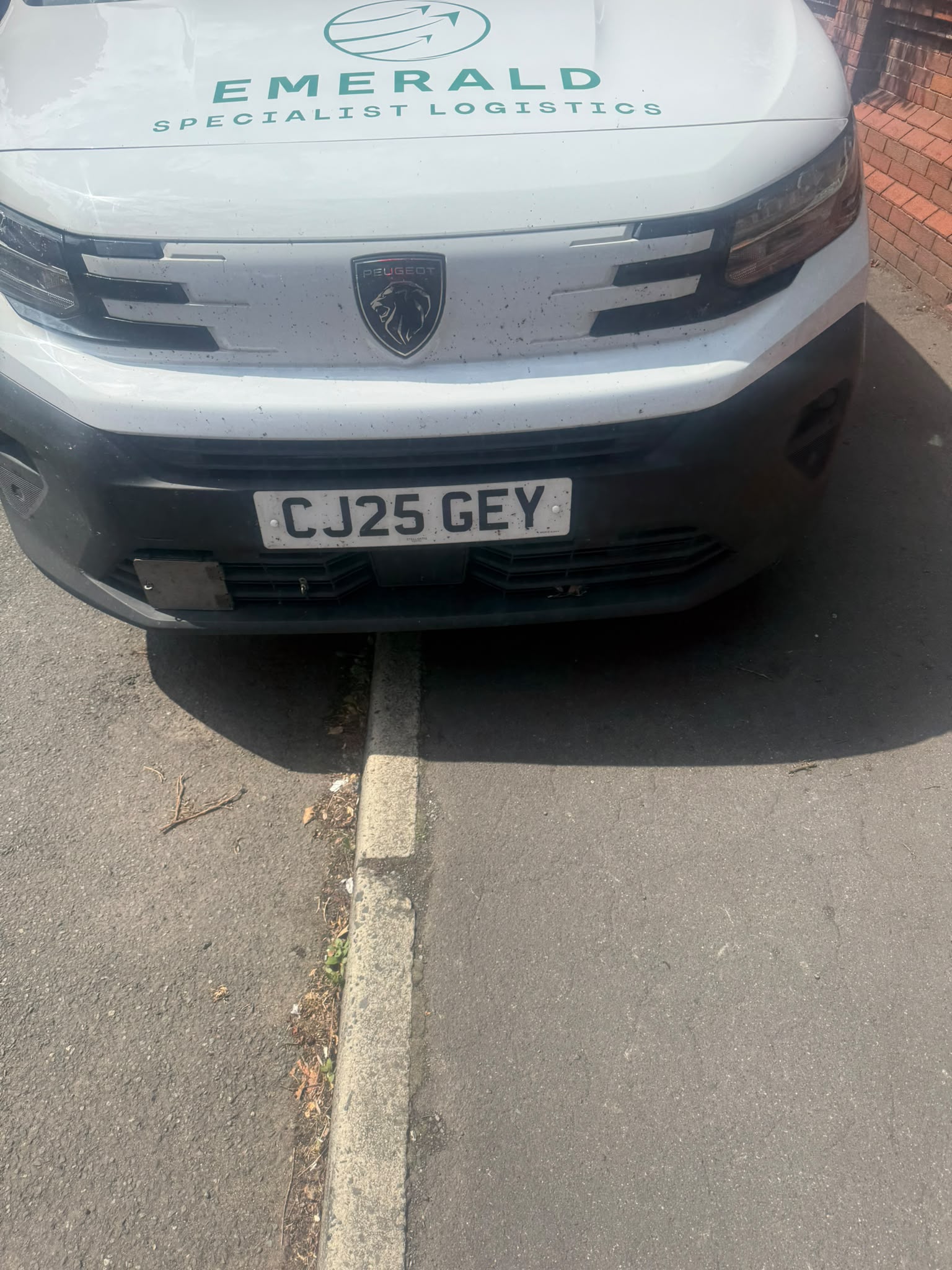 White Peugeot commercial van parked at the kerb during a mobile tyre call-out in Bolton