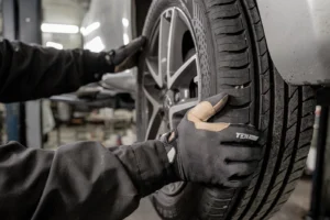 Professional technician fitting a replacement tyre using specialist equipment