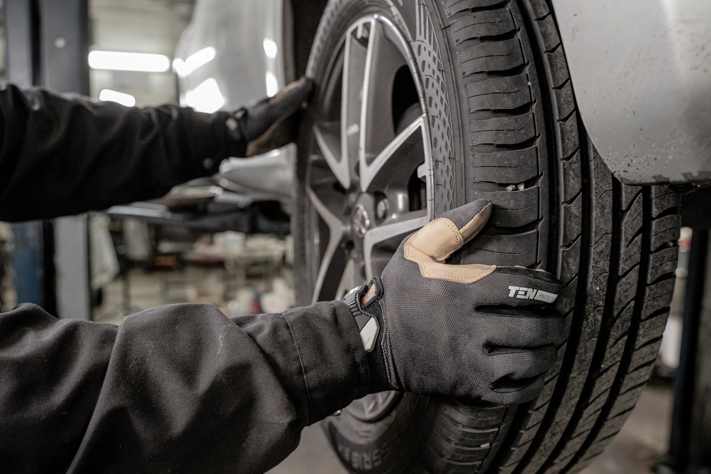 Professional technician fitting an emergency replacement tyre with specialist equipment