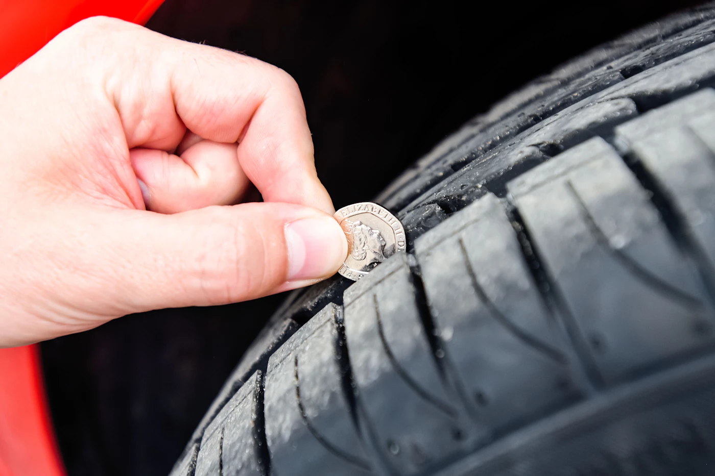 Checking tyre tread depth with a 20p coin before mobile tyre fitting in Bolton