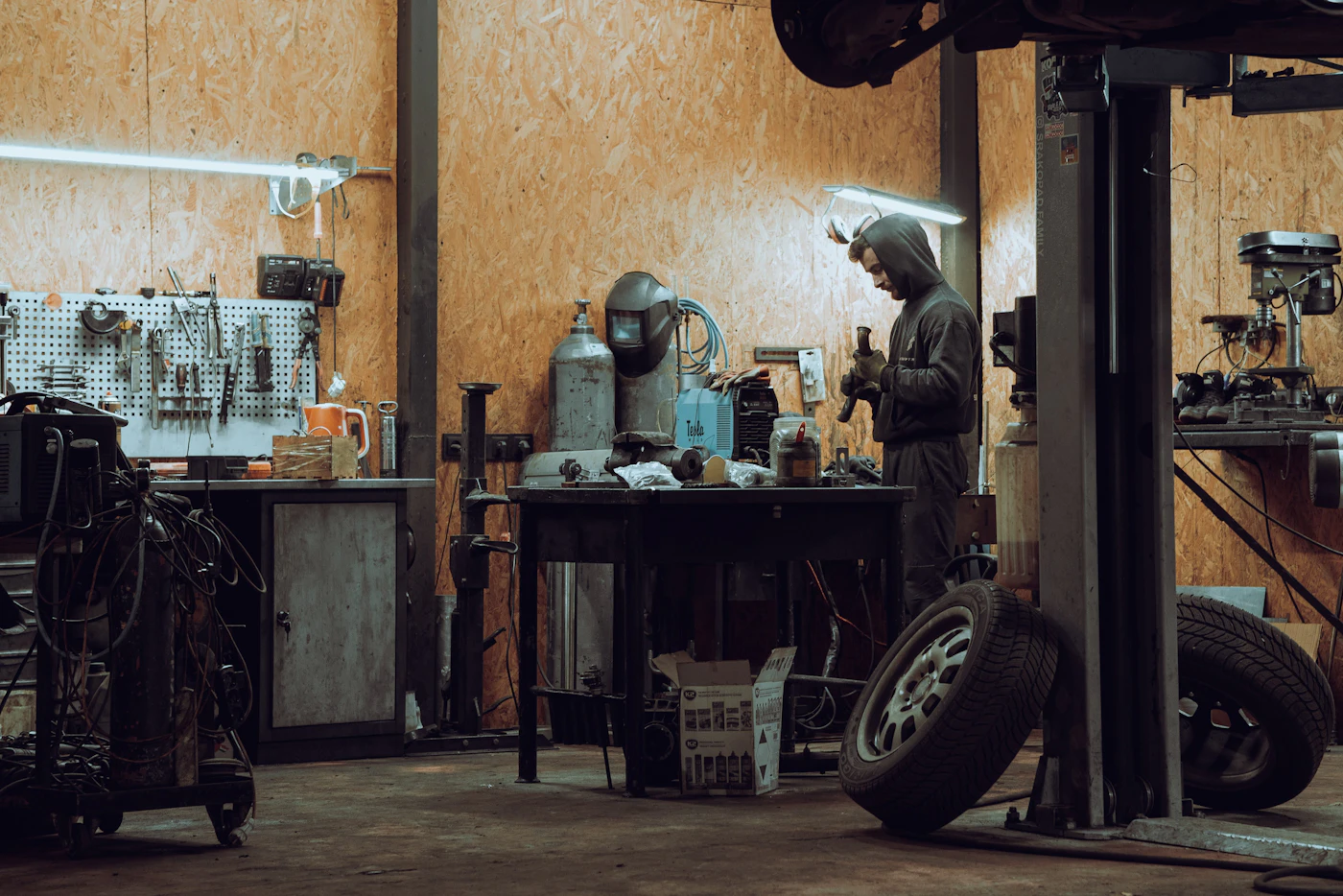 Professional tyre technician preparing emergency replacement equipment in Bolton