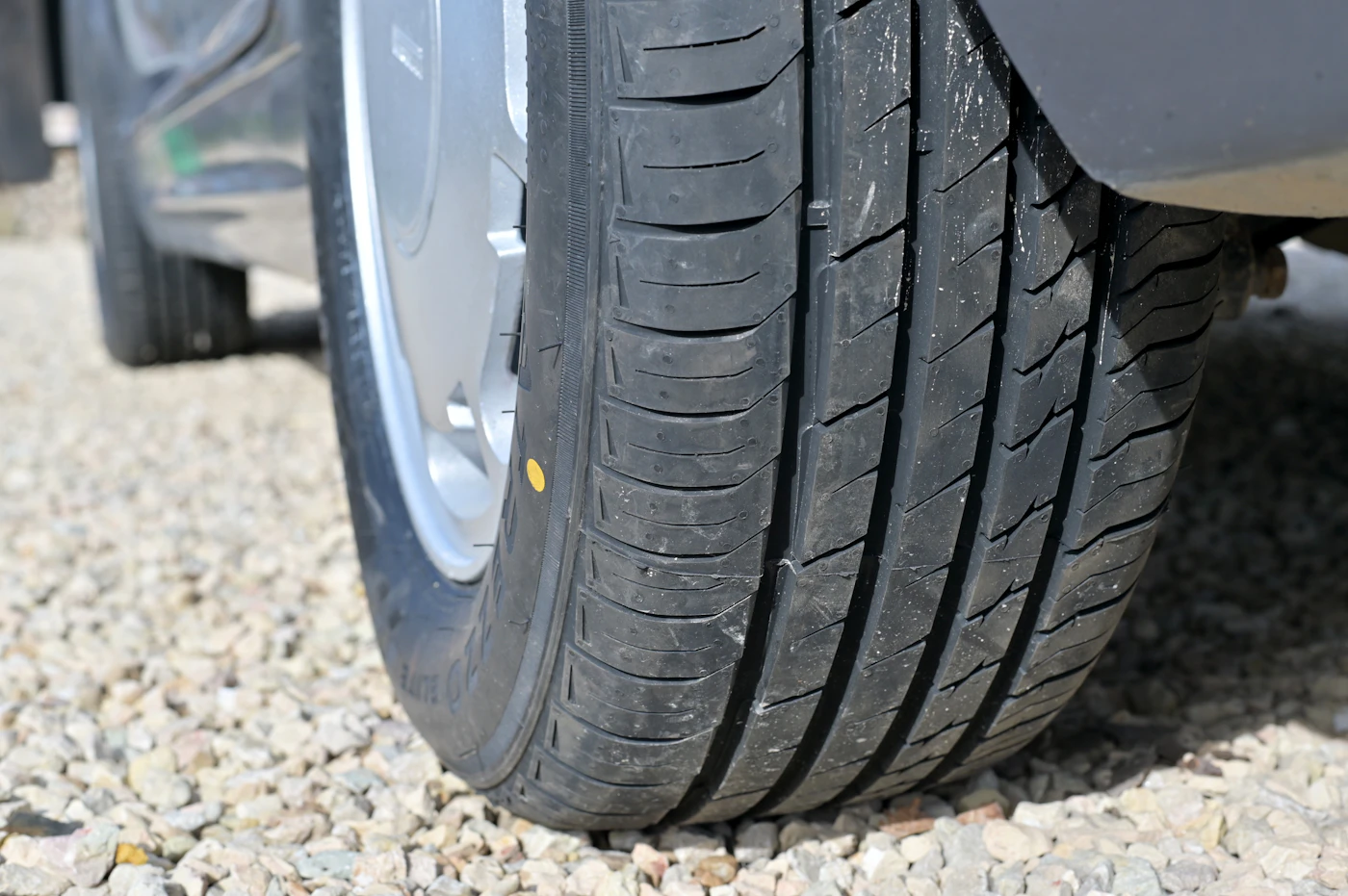 Replacement car tyre inspected before emergency fitting in Bolton